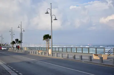 a street with street lights on the side of the beach at Pelides Apartments in Larnaka