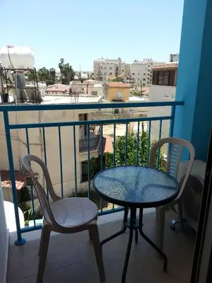 a table and two chairs on a balcony with a view at St. Lazaros House in Larnaka