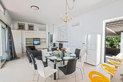 a dining room and kitchen with a table and chairs at Napa Nissi House in Ayia Napa
