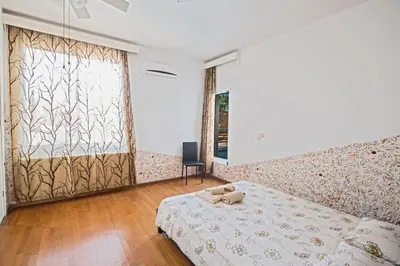 a bedroom with a bed and a large window at Napa Nissi House in Ayia Napa