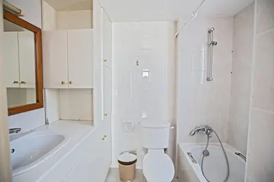 a bathroom with a toilet and a tub and a sink at Napa Nissi House in Ayia Napa