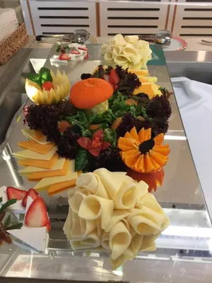 a tray of different types of food on a table at Vrissaki Beach Hotel in Protaras