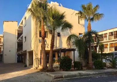 a group of palm trees in front of a building at Napa Gem in Ayia Napa
