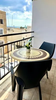 a table and a chair on a balcony at Napa Gem in Ayia Napa