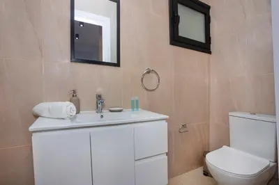 a bathroom with a white sink and a toilet at STAY Zen Studio in Limassol