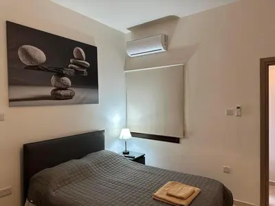 a bedroom with a bed and a mirror at Chariandry Residence, Limassol City Centre in Limassol