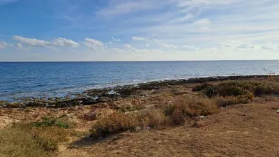 a rocky beach with the ocean in the background at Relaxing Avra Villa with Private Pool & Garden Near Protaras in Paralimni