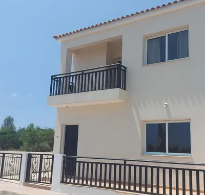 a white house with a balcony with black railing at The T Villa in Protaras