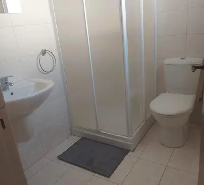 a bathroom with a shower and a toilet and a sink at The T Villa in Protaras