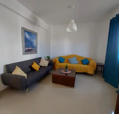 a living room with a couch and a bed at The T Villa in Protaras
