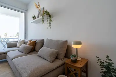 a living room with a couch and a lamp at Hermes 2-Bedroom Apartment in Larnaca in Larnaka