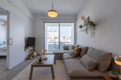 a living room with a couch and a table at Hermes 2-Bedroom Apartment in Larnaca in Larnaka