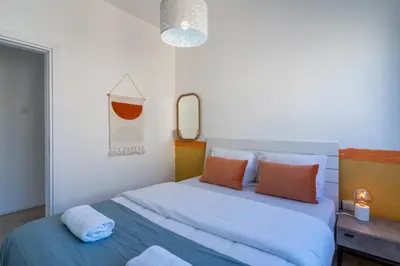 a bedroom with a large bed and a mirror at Citrus 3-Bedroom Apartment in Larnaca in Larnaka