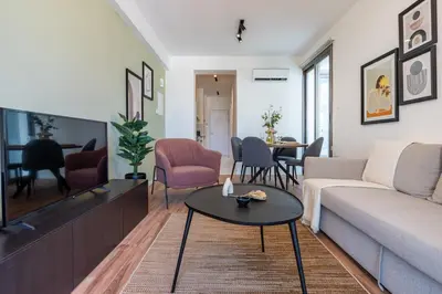 a living room with a couch and a table at Latte's Prime 1-Bedroom Apartment in Larnaca in Larnaka