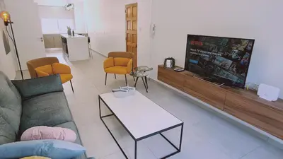 a living room with a couch and a tv at STAY Vital Elegance in Limassol