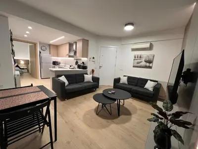 a living room with a couch and a table at Daniela's modern apartment in Strovolos