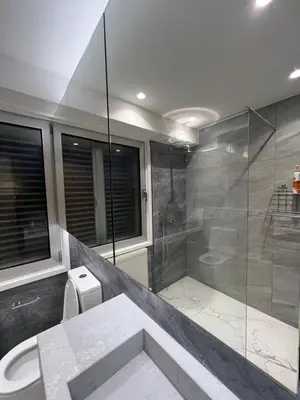 a bathroom with a shower stall and a toilet at Daniela's modern apartment in Strovolos