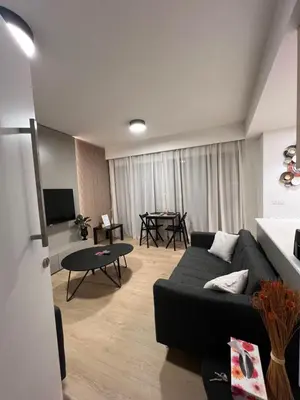 a living room with a couch and a table at Daniela's modern apartment in Strovolos