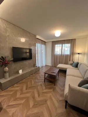 a living room with a couch and a flat screen tv at Natali's luxury apartment in Strovolos