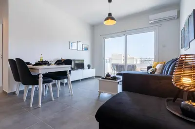a living room with a couch and a table in a room at Diamond’s 2-Bedroom Apartment in Larnaca in Larnaka