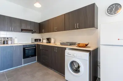 a kitchen with a washer and dryer in it at Diamond’s 2-Bedroom Apartment in Larnaca in Larnaka