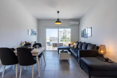 a living room with a couch and a table at Diamond’s 2-Bedroom Apartment in Larnaca in Larnaka