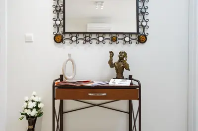 a dressing table with a mirror on a wall at Anchora in Paralimni