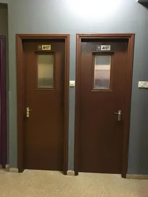 two doors with numbers on them in a room at Past or Tail hostel in Larnaka