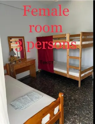 a room with two bunk beds and a sign that reads female room teenagers at Past or Tail hostel in Larnaka