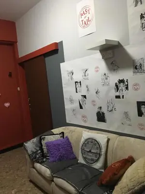 a room with a couch with stickers on the wall at Past or Tail hostel in Larnaka
