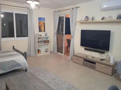 a living room with a flat screen tv on a wall at Xylophagou Rest and Relax 3 Ayia Napa Larnaca 1 bedroom apartment in Xylophaghou