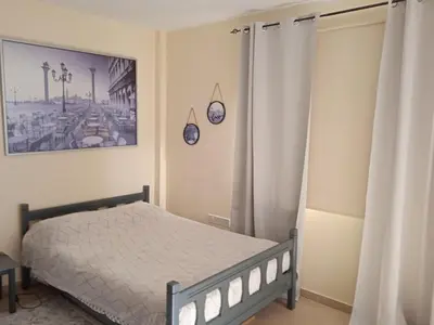 a bedroom with a bed and a picture on the wall at Xylophagou Rest and Relax 3 Ayia Napa Larnaca 1 bedroom apartment in Xylophaghou
