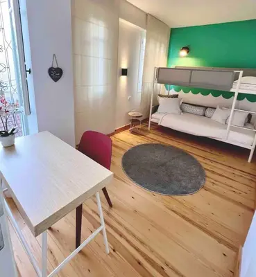 a living room with a bed and a table at Nicosia City Centre Luxury Renovated Apartment in Nicosia