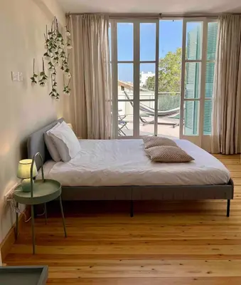 a bedroom with a bed and a large window at Nicosia City Centre Luxury Renovated Apartment in Nicosia