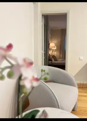 a living room with a couch and pink flowers at Nicosia City Centre Luxury Renovated Apartment in Nicosia