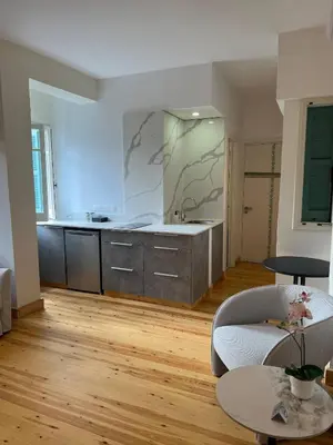 a living room with a kitchen and a table at Nicosia City Centre Luxury Renovated Apartment in Nicosia