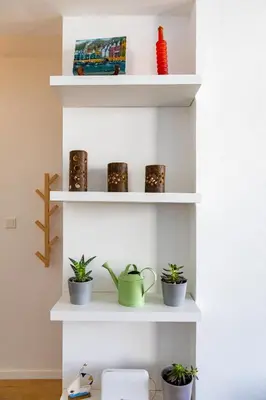 a shelf with potted plants on it at City Center Apartment in Nicosia