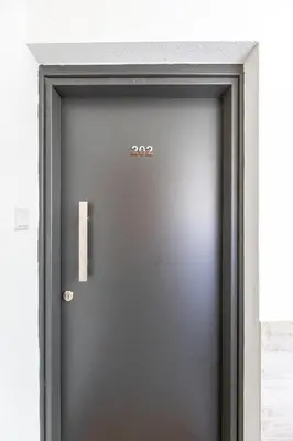 a black door with the number on it at City Center Apartment in Nicosia