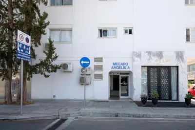 a white building with a sign in front of it at Urban Condo 10 - 2 Bdr in Nicosia