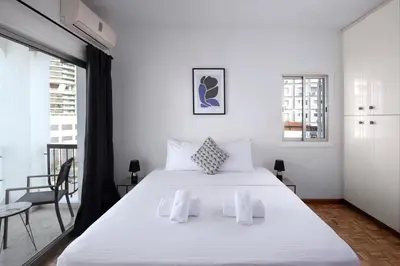 a bedroom with a large white bed and a balcony at Urban Condo 10 - 2 Bdr in Nicosia