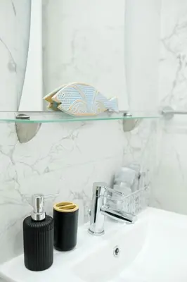a bathroom sink with a glass shelf above it at Lima Residence in Nicosia