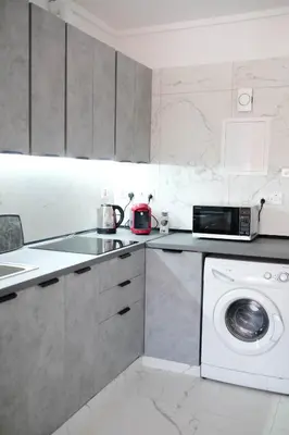 a kitchen with a washing machine and a microwave at Lima Residence in Nicosia