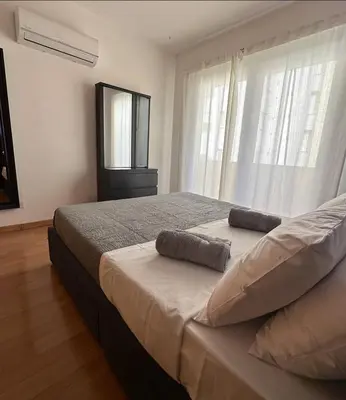 a bedroom with a bed with two pillows on it at Raise Limassol Urban Escape in Limassol