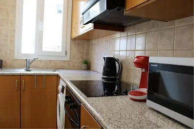 a kitchen with a sink and a stove top oven at Raise Limassol Urban Escape in Limassol