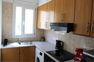 a kitchen with a sink and a stove at Raise Limassol Urban Escape in Limassol