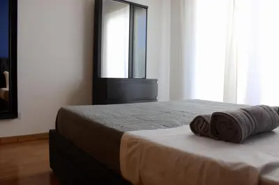 a bedroom with a bed with two towels on it at Raise Limassol Urban Escape in Limassol