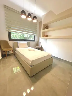 a bedroom with a large bed and a window at Stavri De'Lux Apartment in Larnaka
