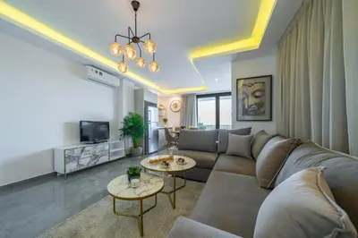 a living room with a couch and two tables at Stavri De'Lux Apartment in Larnaka