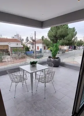 a white table and chairs on a patio at Smart Living-2Bed Pallouriotissa, Nicosia in Nicosia