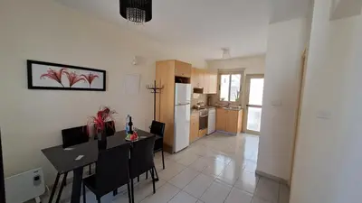 a kitchen and dining room with a table and chairs at Dream Beach House Steps from the Sea & Free Parking in Protaras